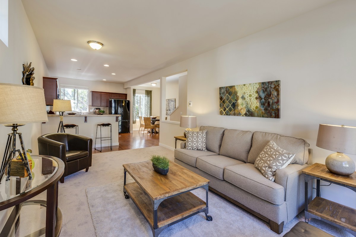 Airy, thoughtfully arranged living room with a sofa, chairs and an uncluttered coffee table