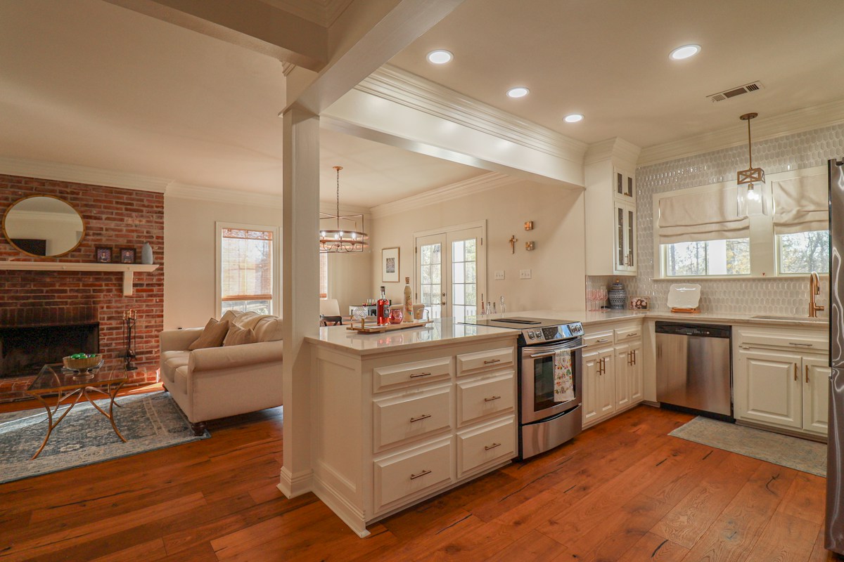 Open kitchen with an island and adjacent living area